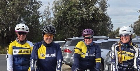 Four Tri Alliance women with their bikes in the carpark